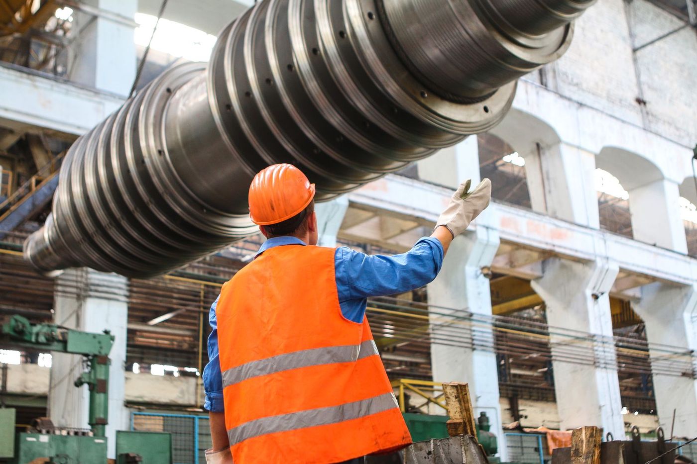 Operator machining a large steel roll